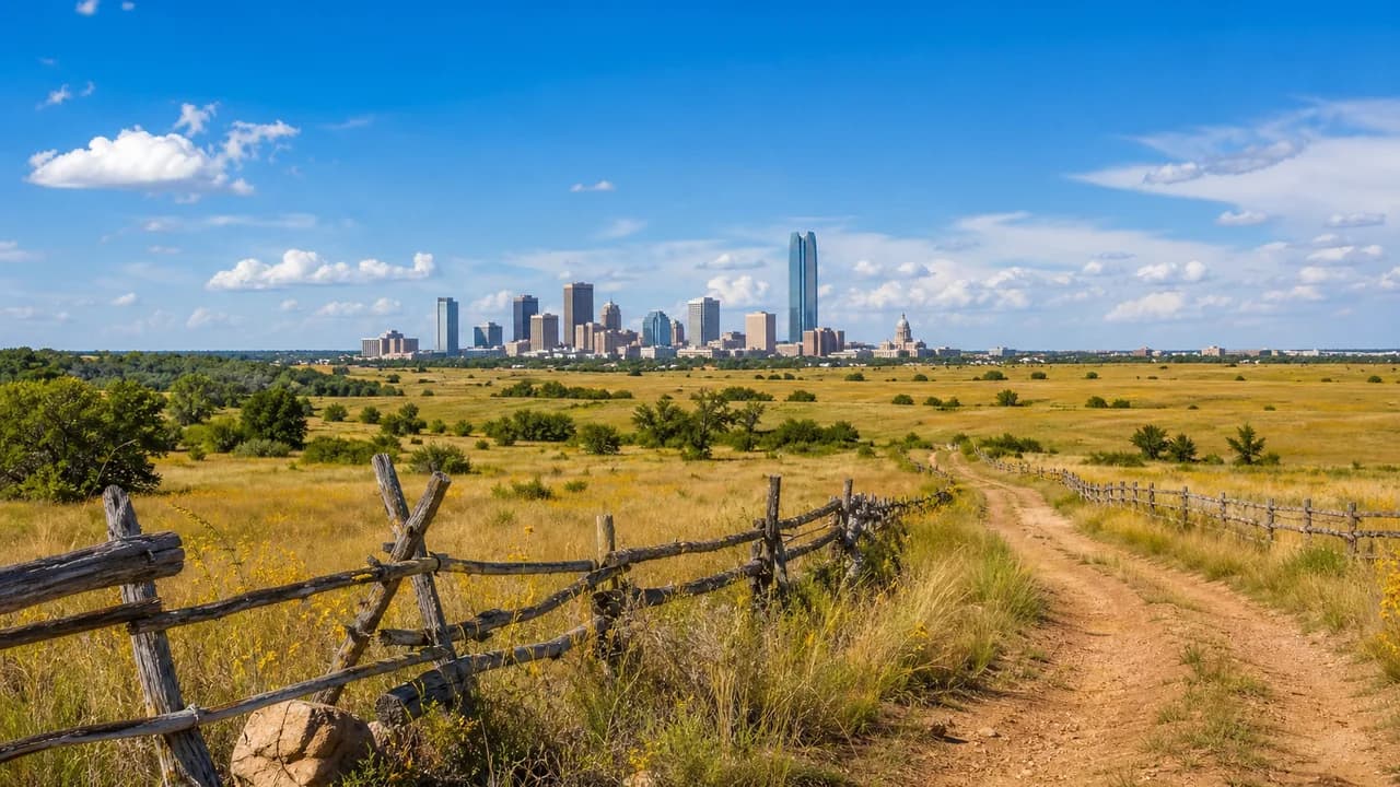Frontier Country prairie, rural road and Oklahoma City skyline under a blue sky